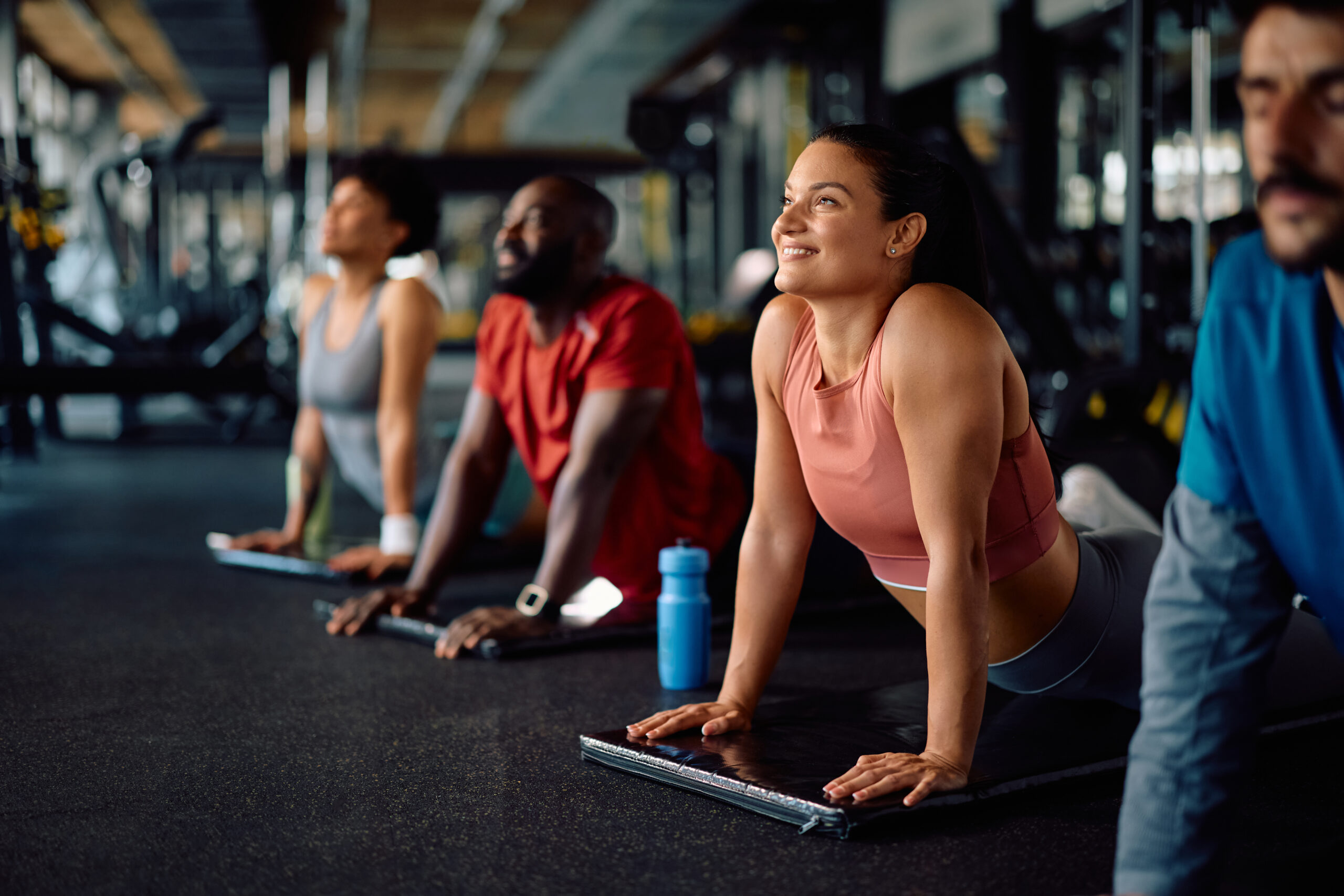 A group doing downward dog in yoga.