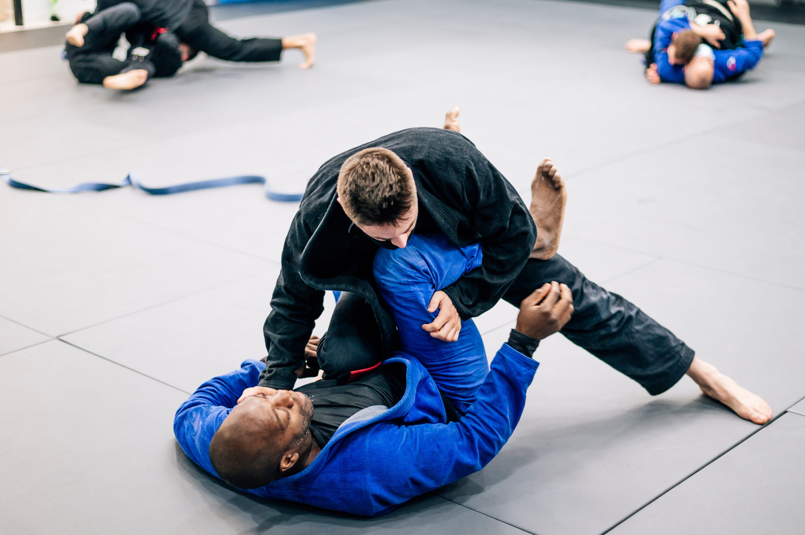 Jiu-jitsu practicers on the floor.